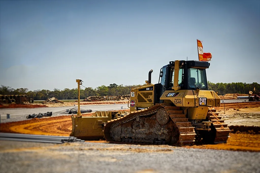 Dozer parked on a graded construction site with fresh base material